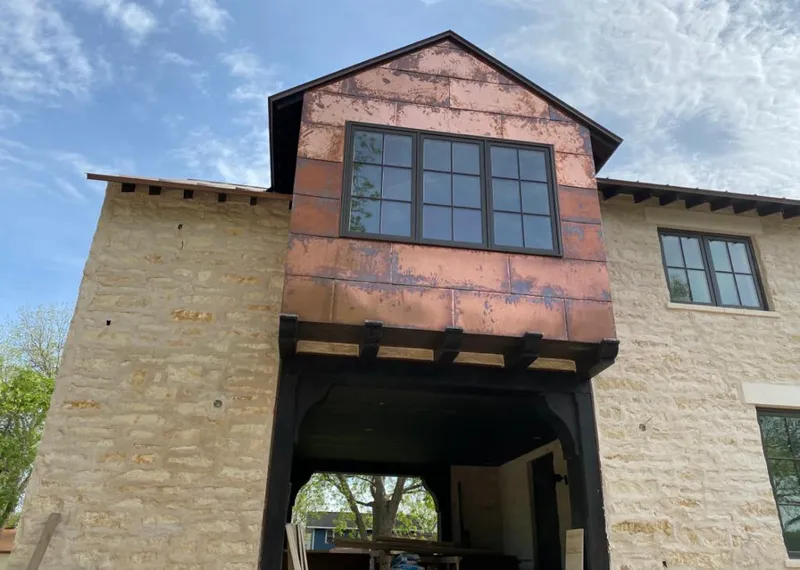 Copper metal panel facade on a stone building for Skylight Installation in Santa Maria