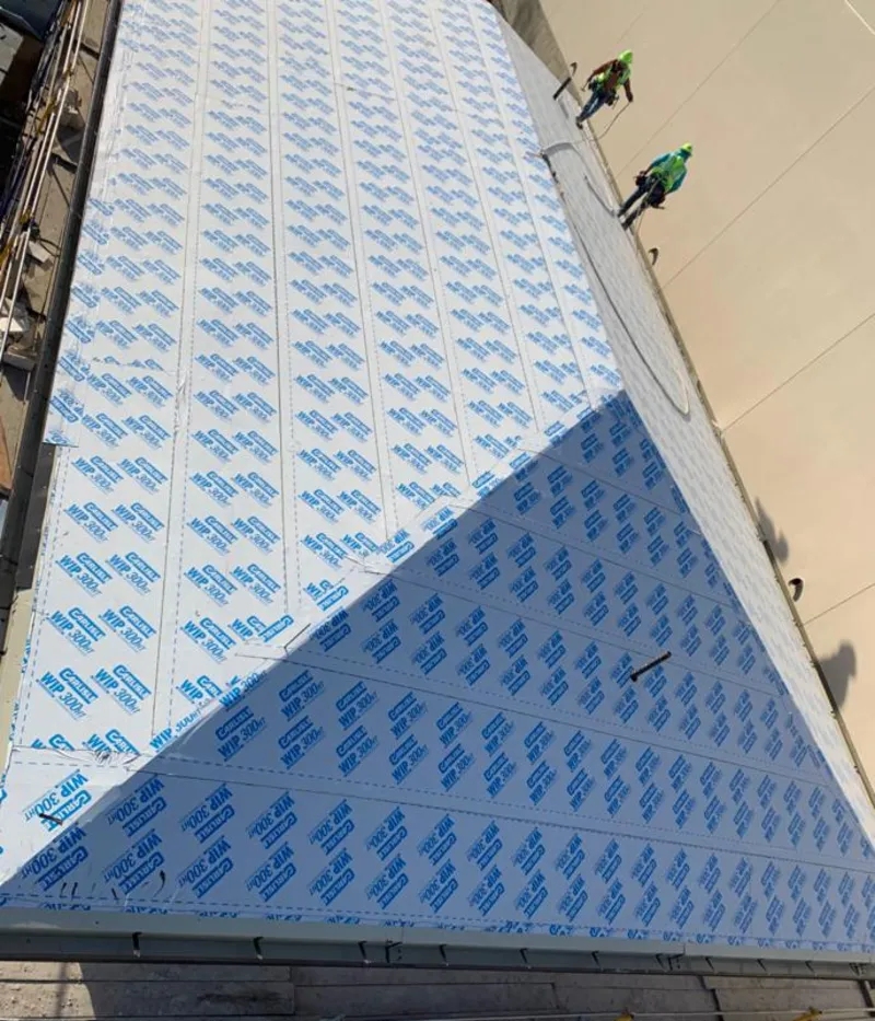 Professional roofers installing underlayment on a metal roof in Santa Maria